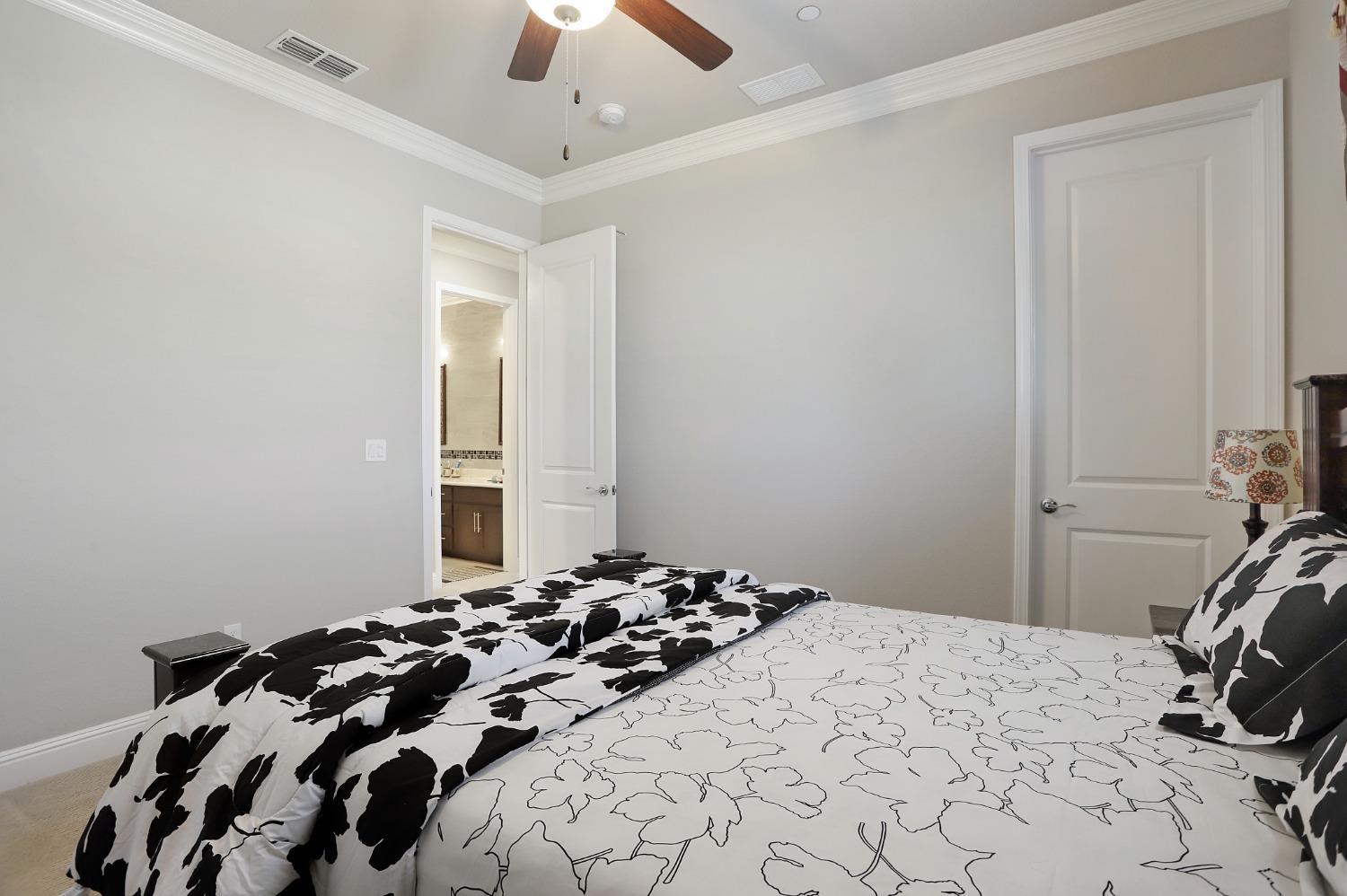 2925 Fuchsia Drive Lodi, CA 95242 - Photo 19 of 44 a bedroom with a bed and a chair
