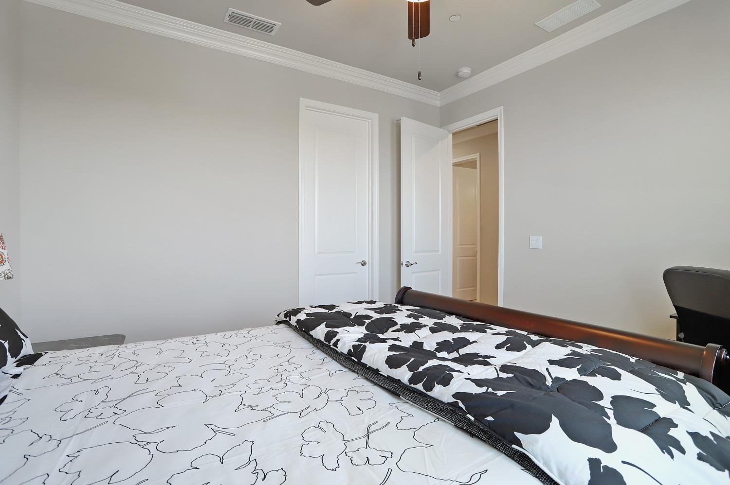 2925 Fuchsia Drive Lodi, CA 95242 - Photo 21 of 44 a bedroom with a bed and a lamp