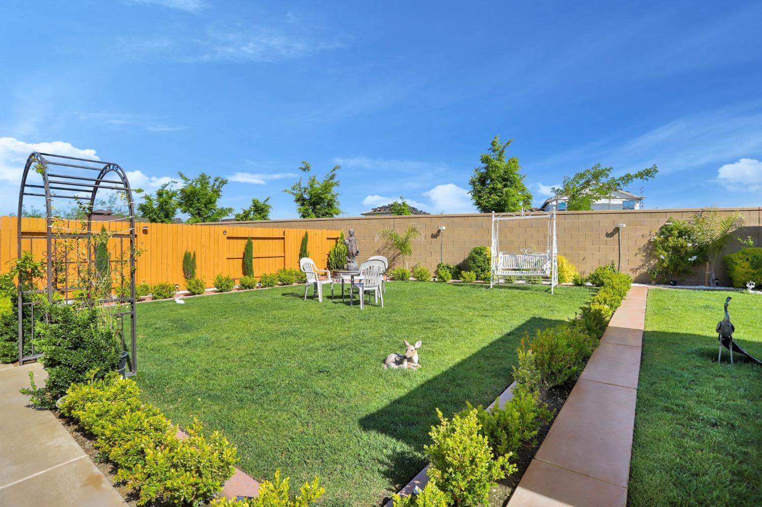 2925 Fuchsia Drive Lodi, CA 95242 - Photo 40 of 44 a view of a garden with a building in the background