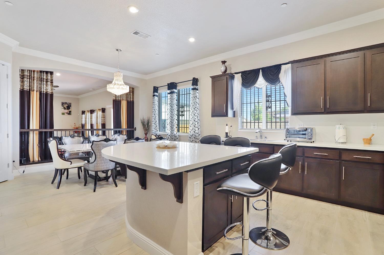 2925 Fuchsia Drive Lodi, CA 95242 - Photo 9 of 44 a kitchen with a table chairs sink and cabinets
