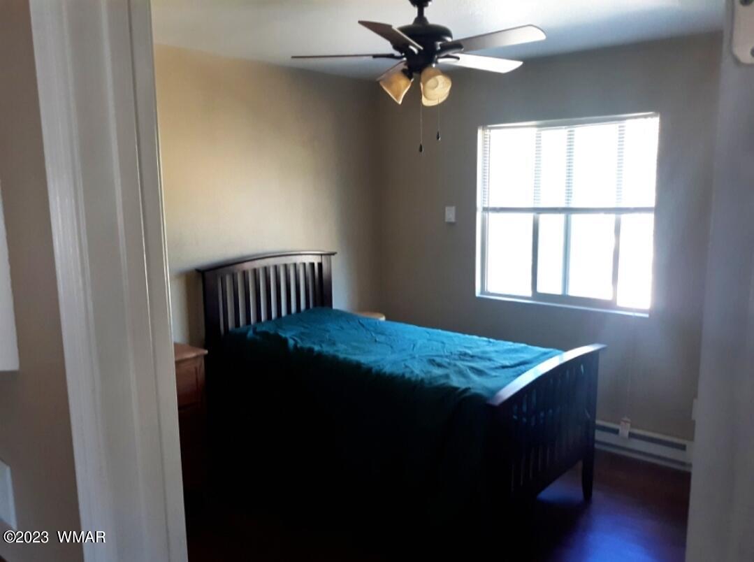 3521 Deer Track Trail Overgaard, AZ 85933 - Photo 5 of 7 a bedroom with a bed and a window
