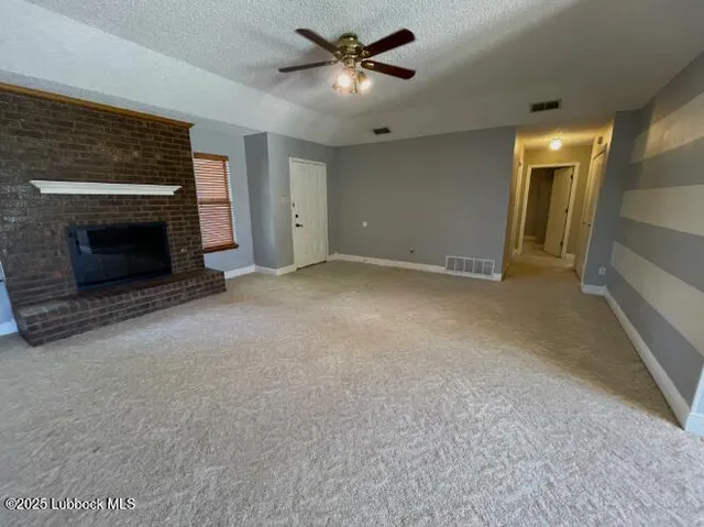 a view of an empty room with a fireplace