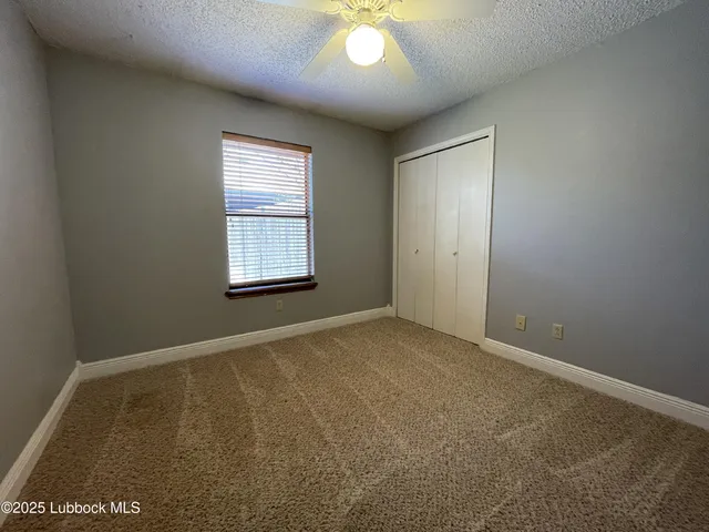 an empty room with windows and closet