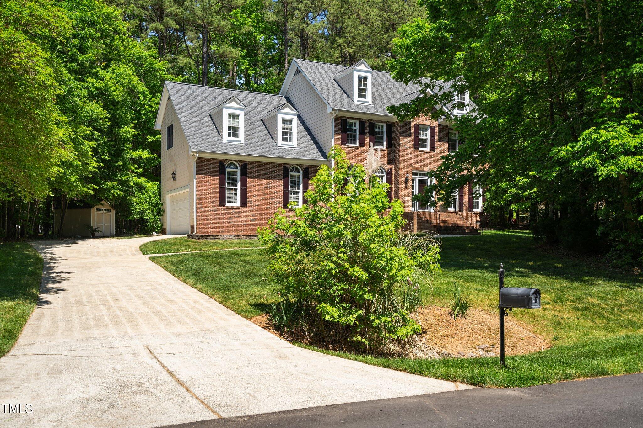 2404 Sunnystone Way Raleigh, NC 27613 - Photo 4 of 51 a front view of a house with a yard and potted plants