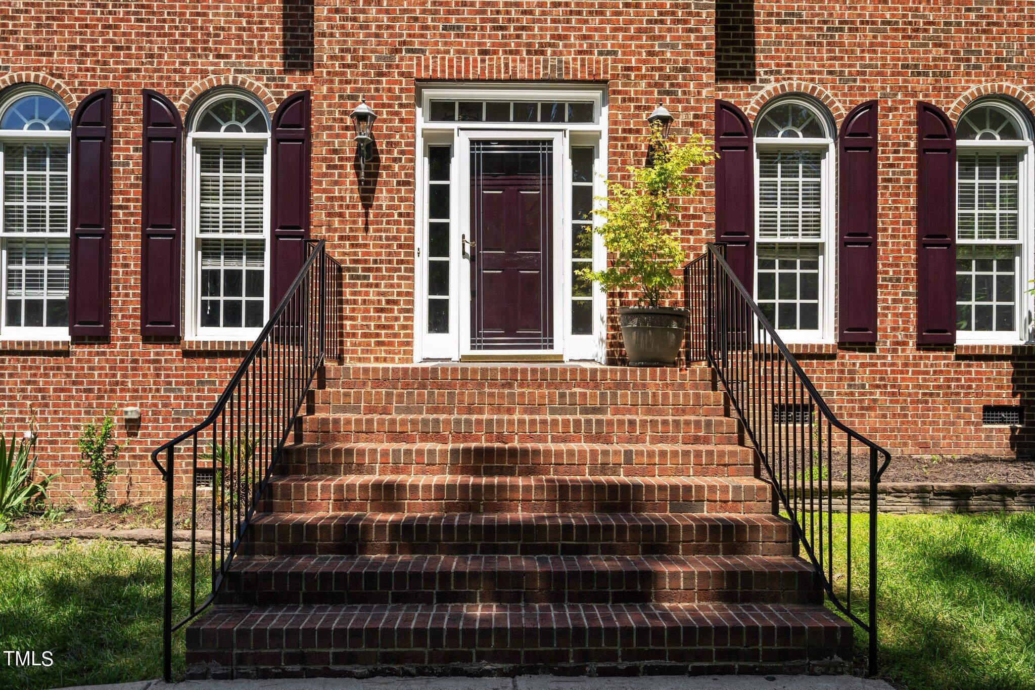 2404 Sunnystone Way Raleigh, NC 27613 - Photo 5 of 51 a view of a brick house with many windows