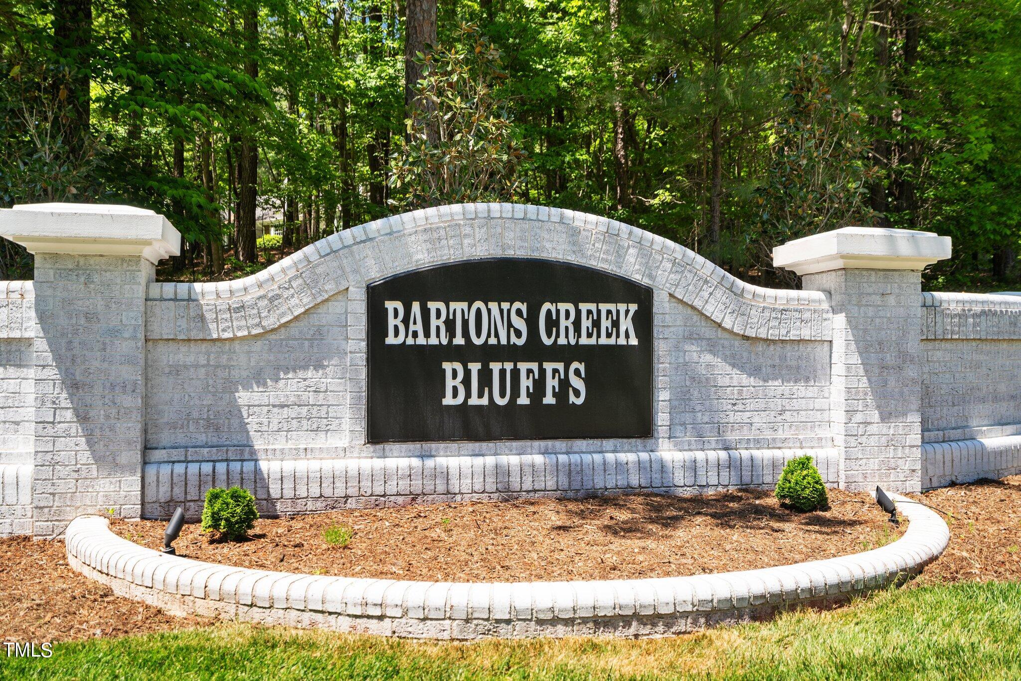 2404 Sunnystone Way Raleigh, NC 27613 - Photo 6 of 51 a sign that is sitting on a brick wall