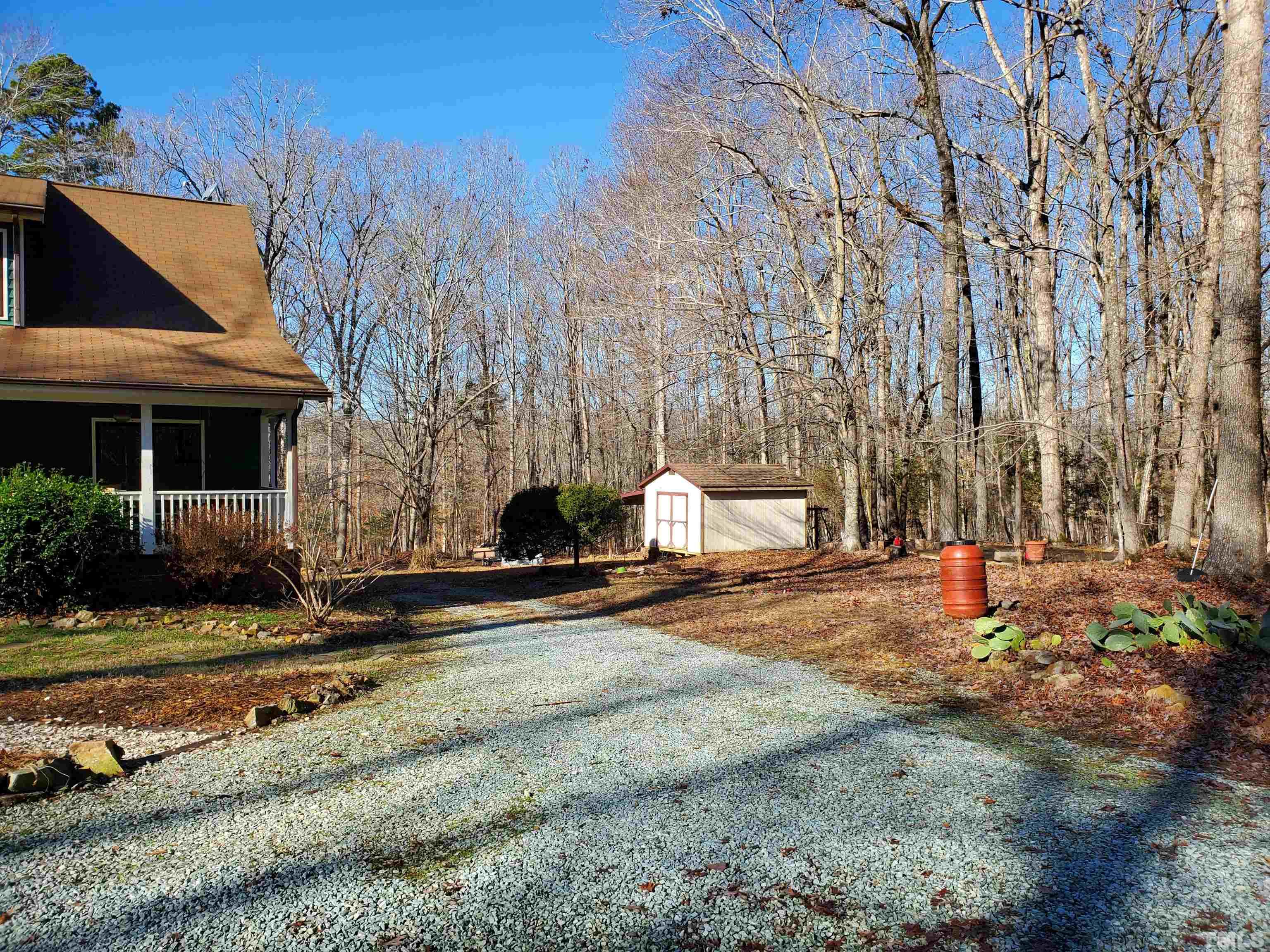 369 Potluck Farm Road Rougemont, NC 27572 - Photo 5 of 38 a view of a house with backyard and trees