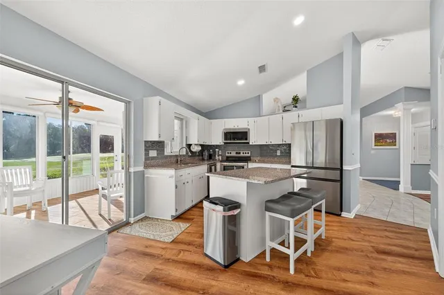 a kitchen with granite countertop a stove and a refrigerator