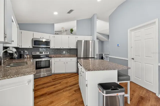 a kitchen with granite countertop a sink and a granite counter tops