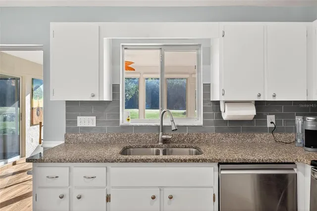 a spacious bedroom with a bed and a large window