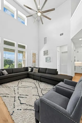 a kitchen with stainless steel appliances kitchen island granite countertop a dining table chairs and sink