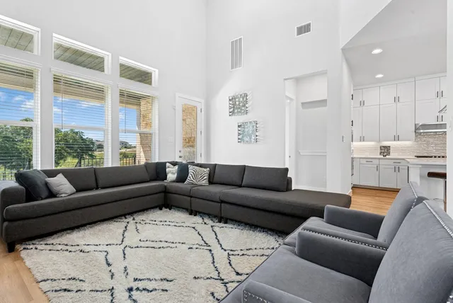 a large kitchen with a table chairs appliances and wooden floor