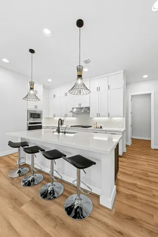 a spacious bedroom with a bed and a flat screen tv