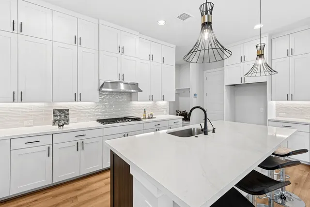 a spacious bedroom with a bed a couch and a flat screen tv