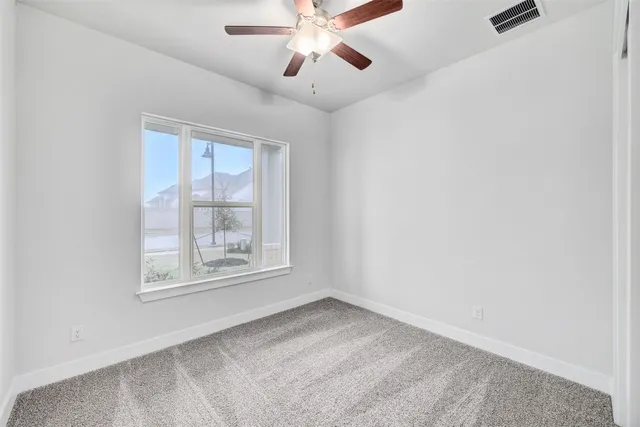 a front view of a house with a yard and potted plants