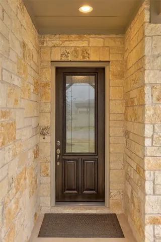 a view of a bedroom with a bed and wooden floor