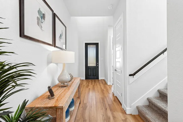 a view of living room filled with furniture and wooden floor