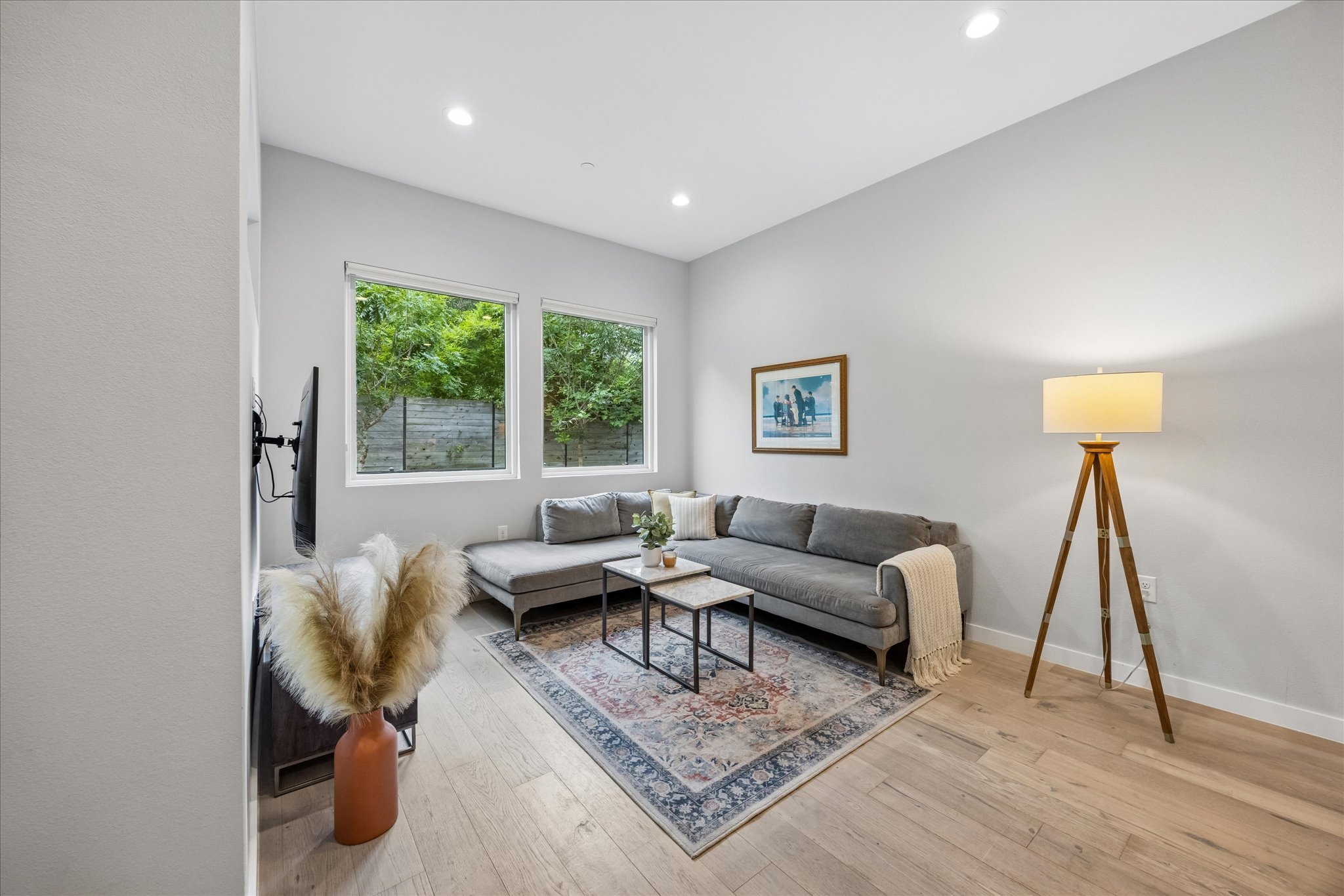 2108 Tillery Street, Unit 9 Austin, TX 78723 - Photo 8 of 25 Light-filled living room with large picture windows overlooking backyard