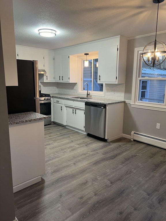 72 Clement Street Springfield, MA 01118 - Photo 11 of 36 a kitchen with granite countertop a stove a sink and a refrigerator