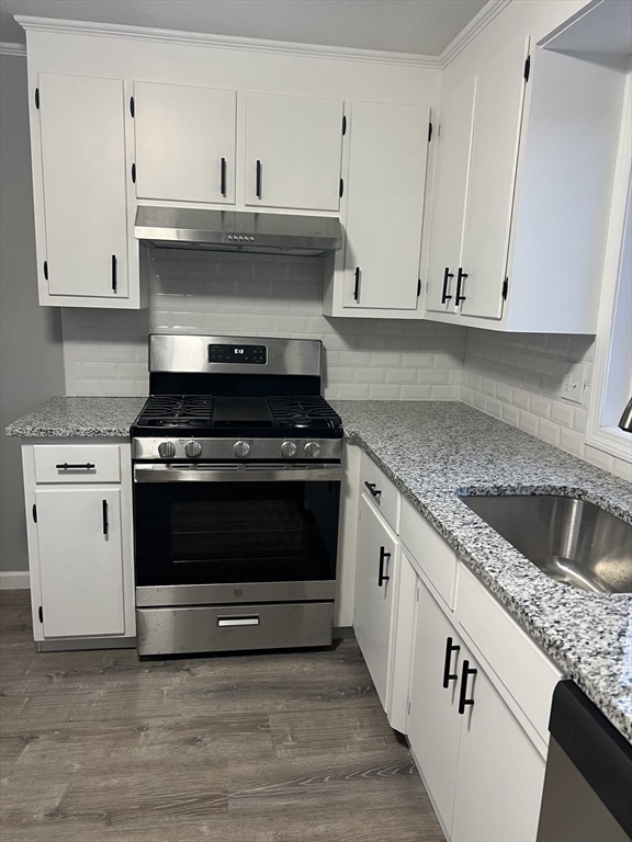 72 Clement Street Springfield, MA 01118 - Photo 12 of 36 a kitchen with granite countertop a stove and a sink