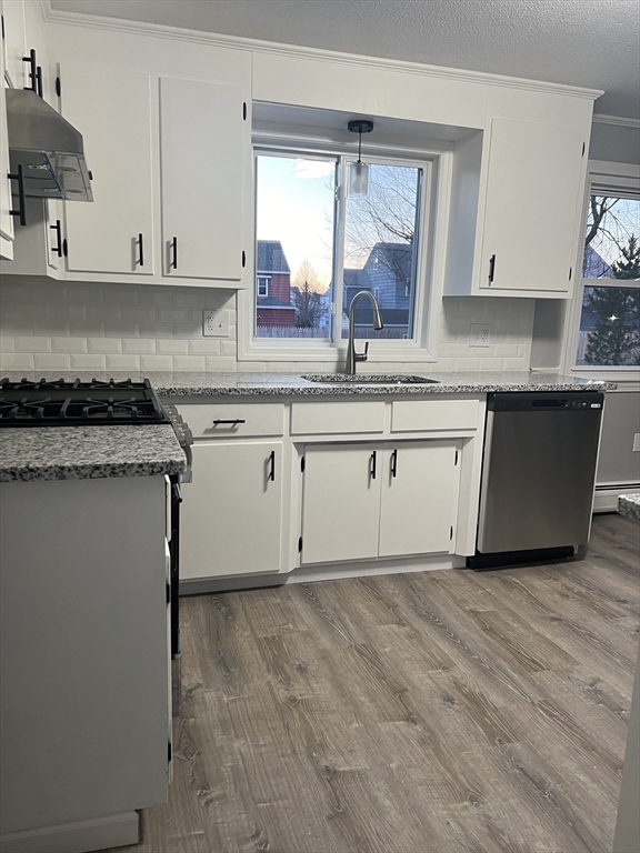 72 Clement Street Springfield, MA 01118 - Photo 13 of 36 a kitchen with granite countertop white cabinets and white appliances
