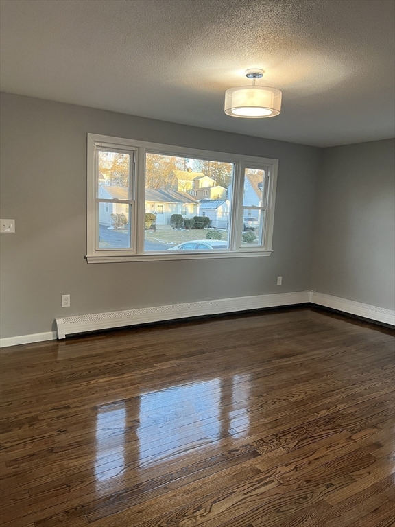 72 Clement Street Springfield, MA 01118 - Photo 17 of 36 an empty room with wooden floor and windows