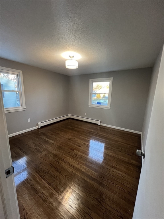 72 Clement Street Springfield, MA 01118 - Photo 20 of 36 an empty room with wooden floor and windows