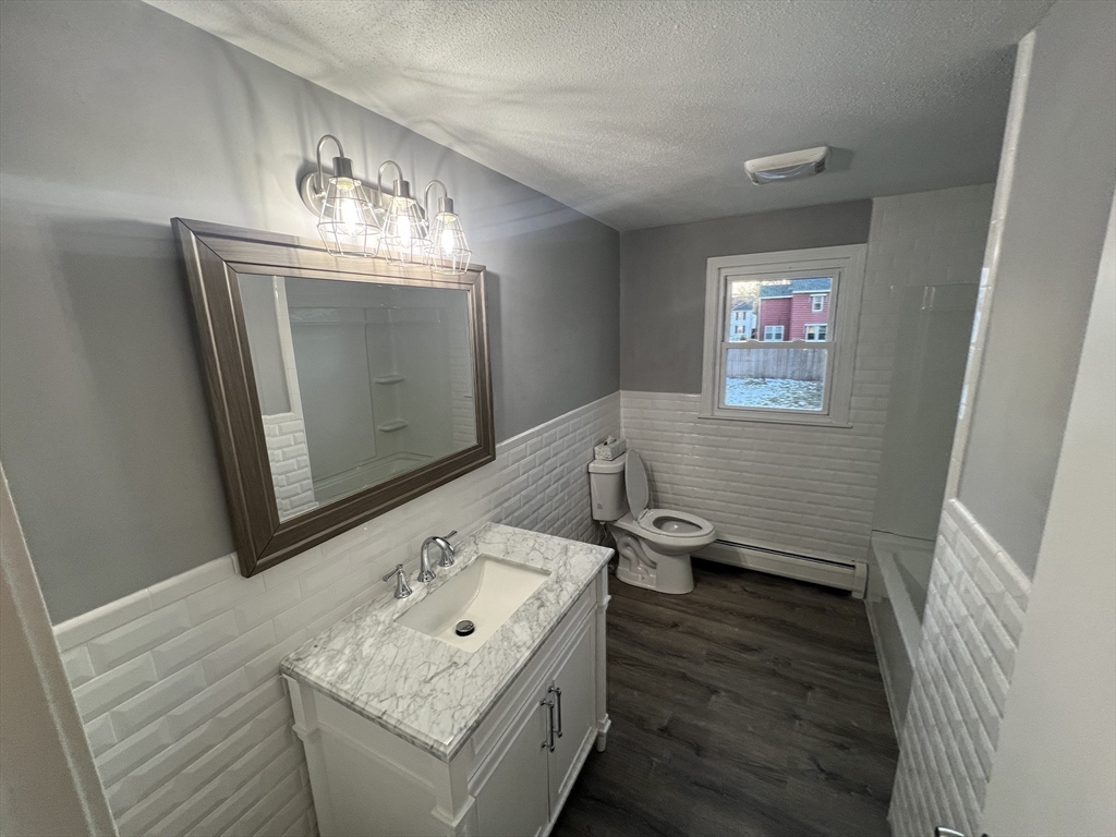 72 Clement Street Springfield, MA 01118 - Photo 21 of 36 a bathroom with a sink a mirror and a toilet