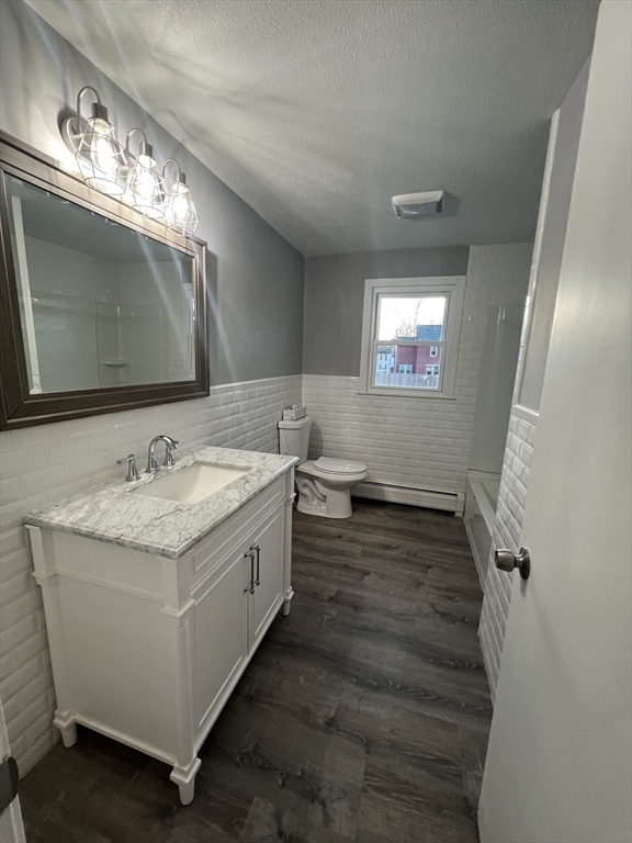 72 Clement Street Springfield, MA 01118 - Photo 24 of 36 a bathroom with a granite countertop sink a mirror and a vanity