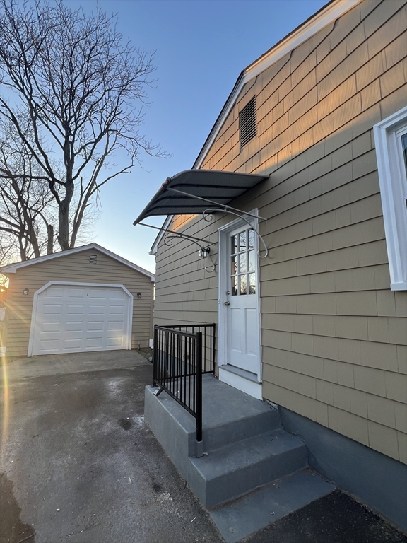 72 Clement Street Springfield, MA 01118 - Photo 4 of 36 a side view of a house with a yard and deck