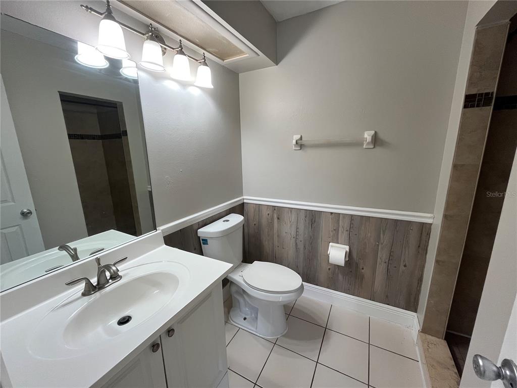 4142 Flying Fortress Avenue Kissimmee, FL 34741 - Photo 11 of 12 a bathroom with a sink a toilet and a mirror