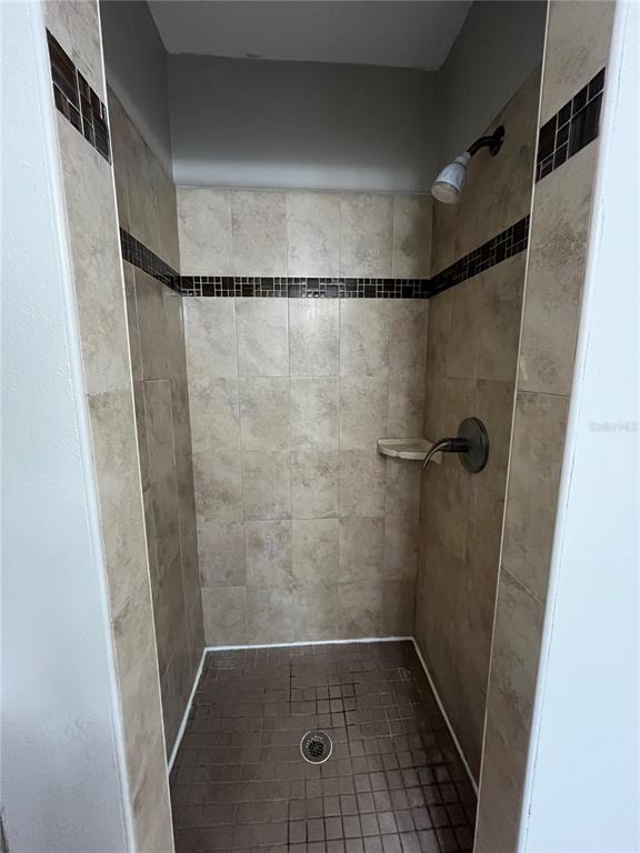 4142 Flying Fortress Avenue Kissimmee, FL 34741 - Photo 12 of 12 a bathroom with a glass shower door