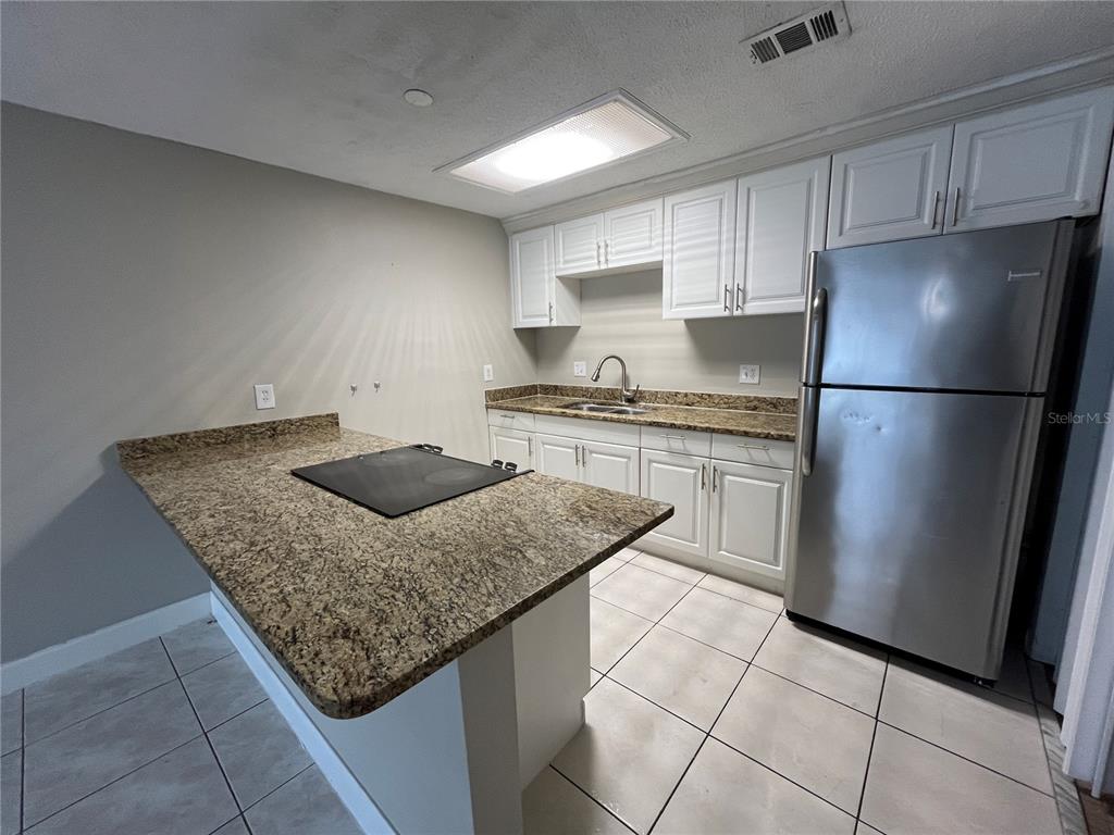 4142 Flying Fortress Avenue Kissimmee, FL 34741 - Photo 5 of 12 a kitchen with appliances cabinets and a sink