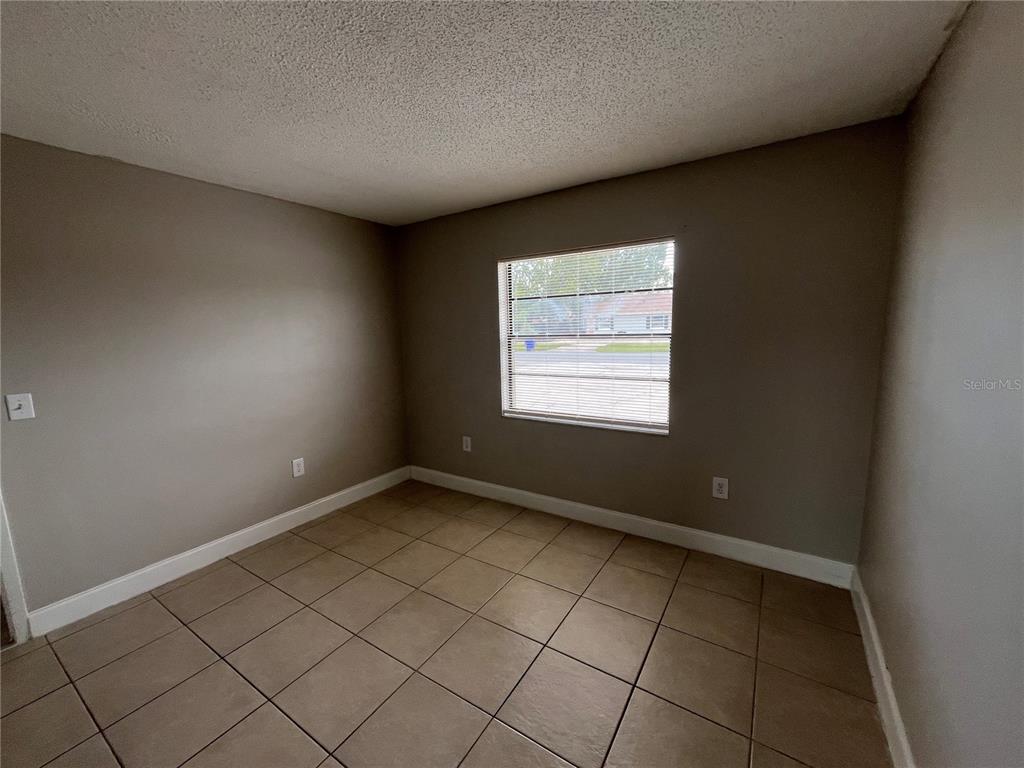 4142 Flying Fortress Avenue Kissimmee, FL 34741 - Photo 6 of 12 an empty room with windows