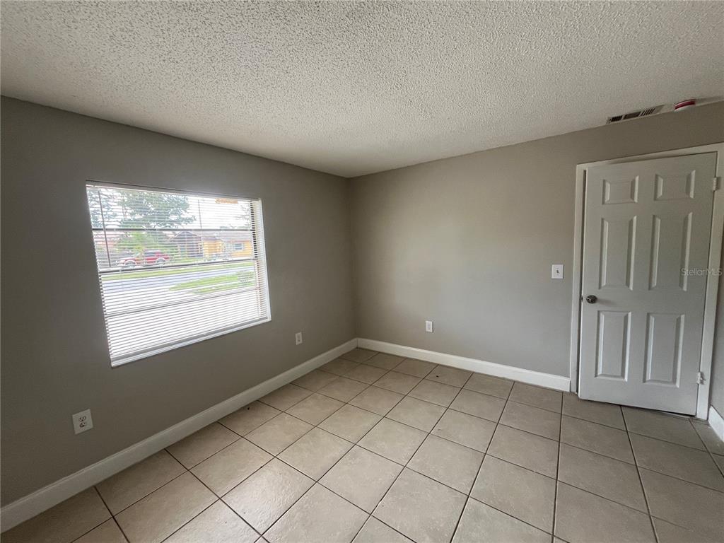 4142 Flying Fortress Avenue Kissimmee, FL 34741 - Photo 8 of 12 an empty room with windows