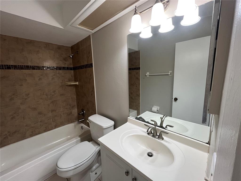 4142 Flying Fortress Avenue Kissimmee, FL 34741 - Photo 10 of 12 a bathroom with a sink a toilet and shower