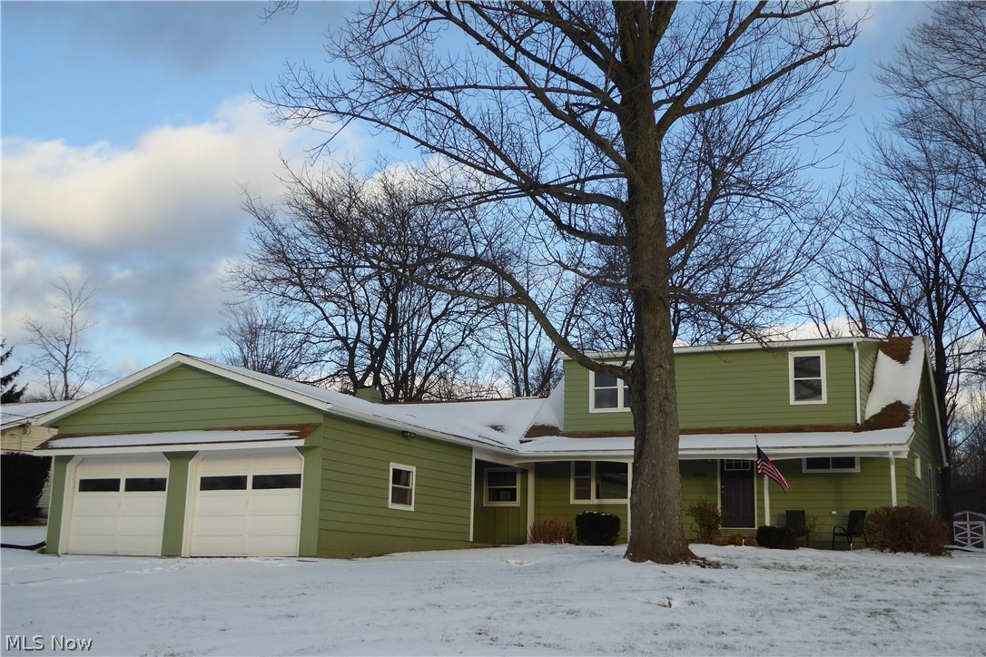 10355 Auburn Road Chardon, OH 44024 - Photo 2 of 19 Covered Front Porch, Side Foyer Entry as Well, Two Car Attached Garage with Openers and Wall Storage!