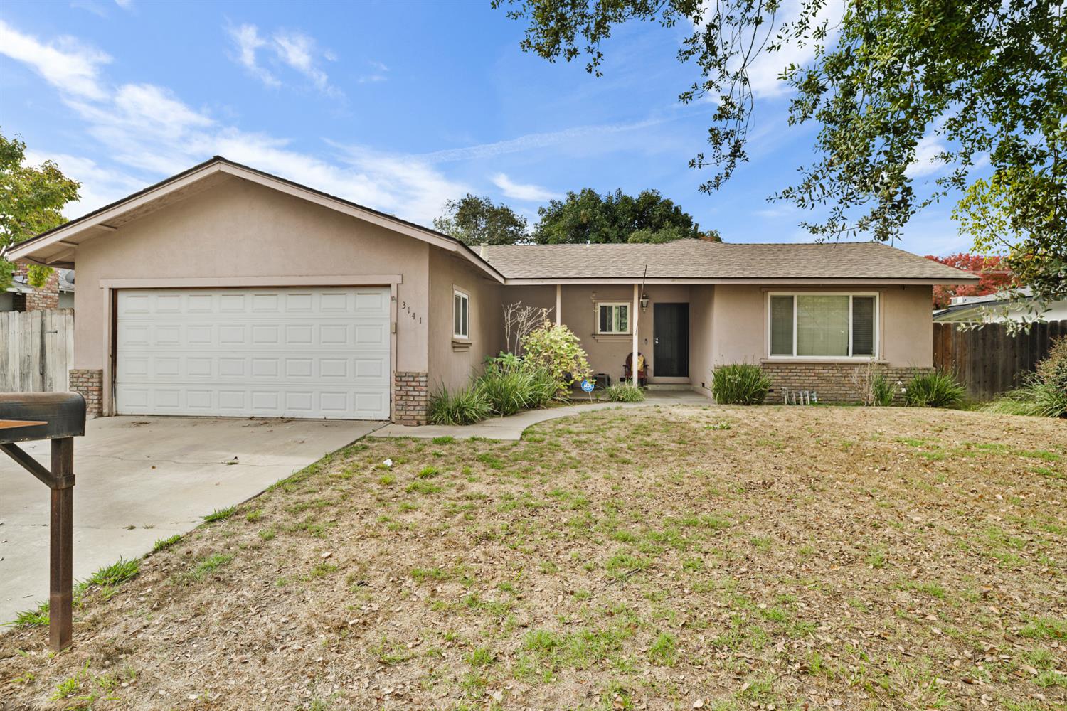 3141 Lisa Drive Modesto, CA 95350 - Photo 1 of 29 a front view of house with yard and trees around