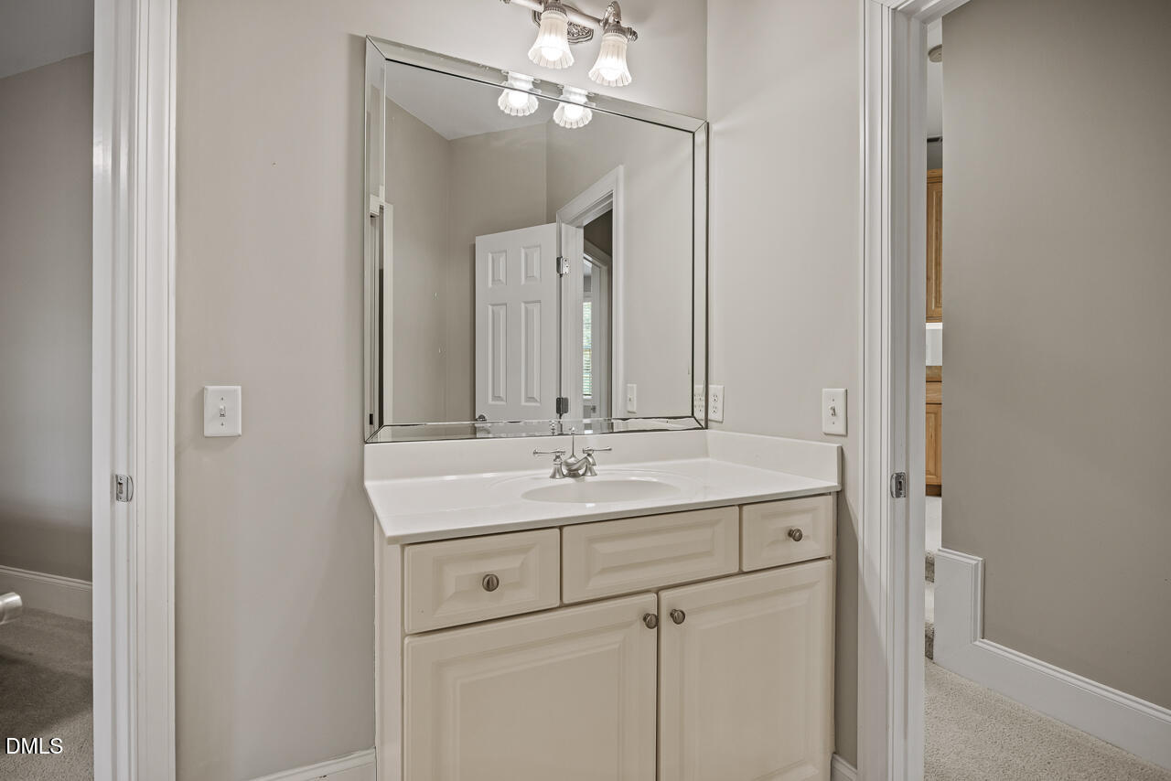 4004 Frontenac Court Apex, NC 27539 - Photo 43 of 61 a bathroom with a sink and a mirror
