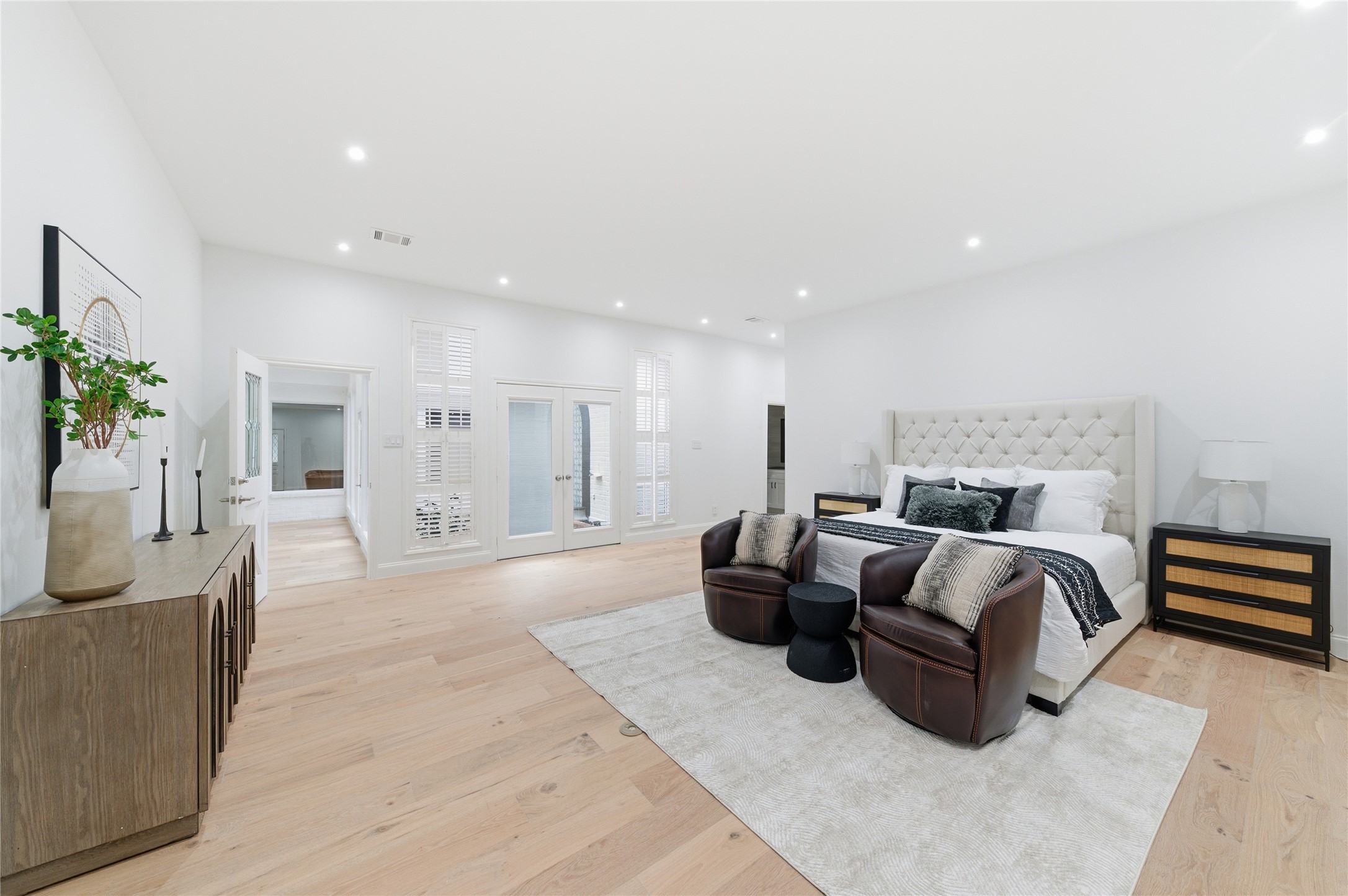 15827 Foxgate Road Houston, TX 77079 - Photo 17 of 37 Expansive primary suite with oak wood floors and frech doors opening to the courtyard. A large retreat with plenty of space for a sitting area or additonal furnishings