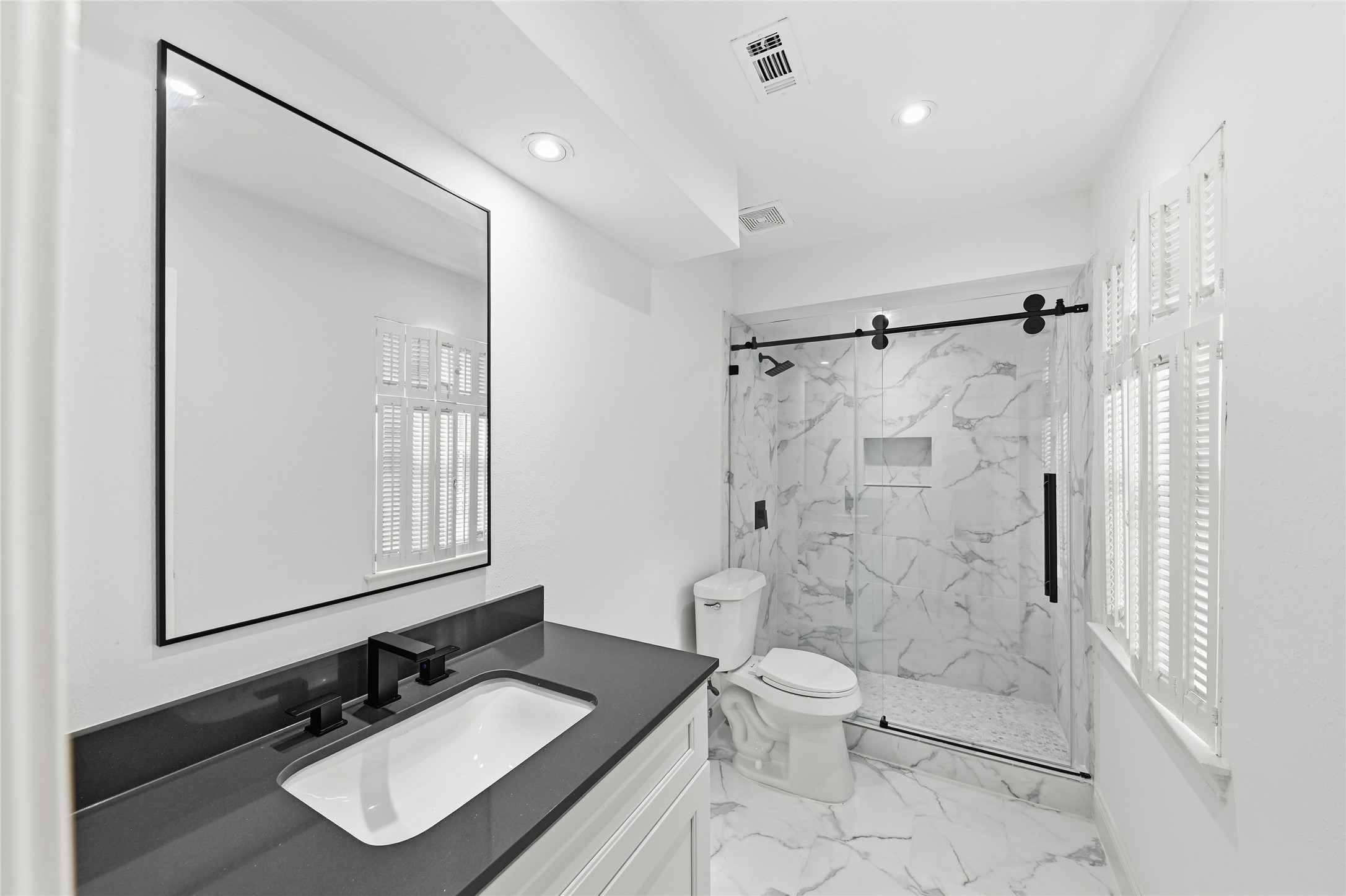 15827 Foxgate Road Houston, TX 77079 - Photo 27 of 37 Stylish full bath adjoining the game room, featuring full tile shower with sliding glass doors and a modern vanity. Perfect for guests, entertaining, or added convenience in this verstatile upstairs space