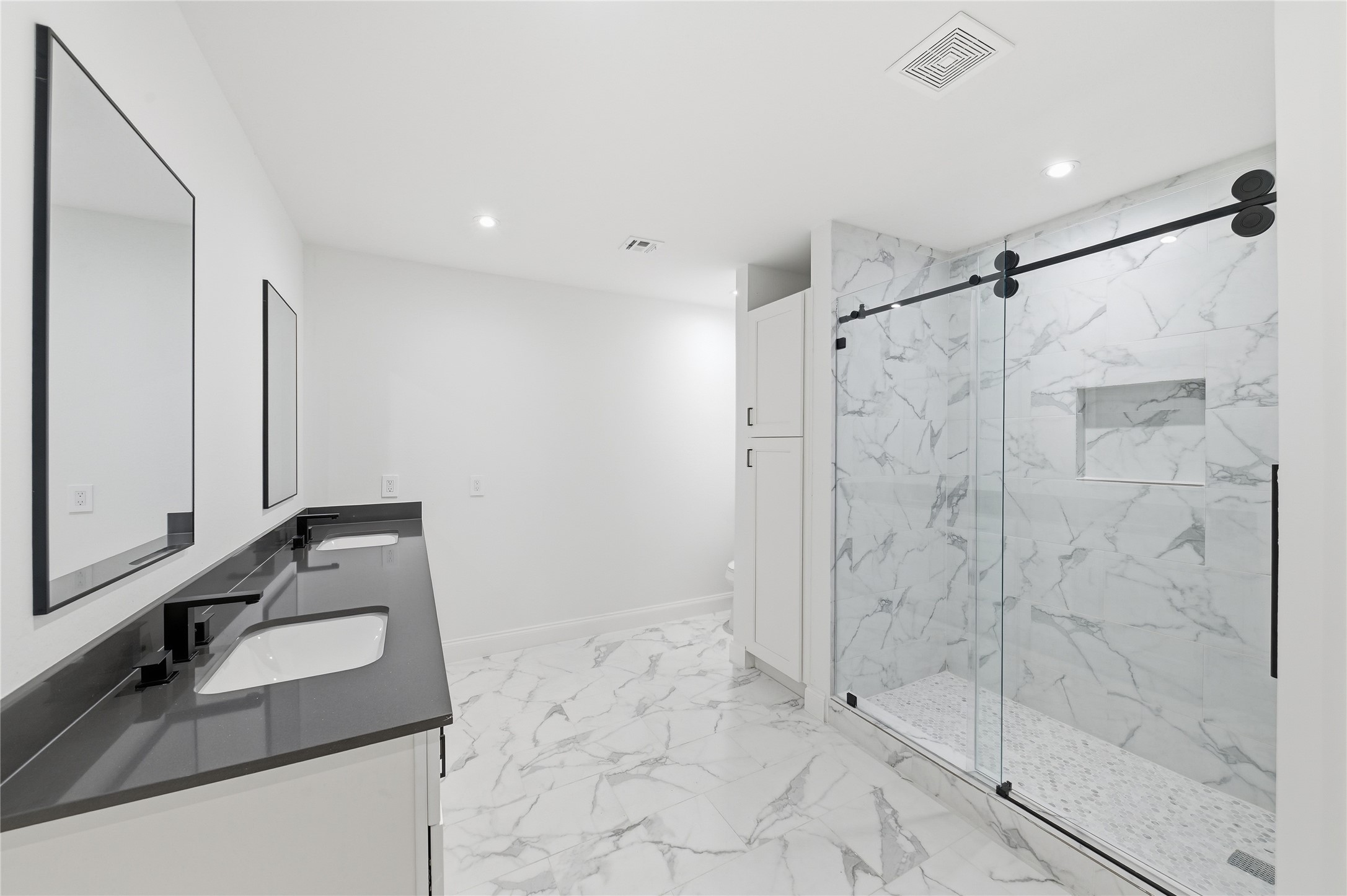 15827 Foxgate Road Houston, TX 77079 - Photo 29 of 37 Bright modern bathroom for the ensuite bedroom with large walk in shower. Ample storage deliver both style and functionality