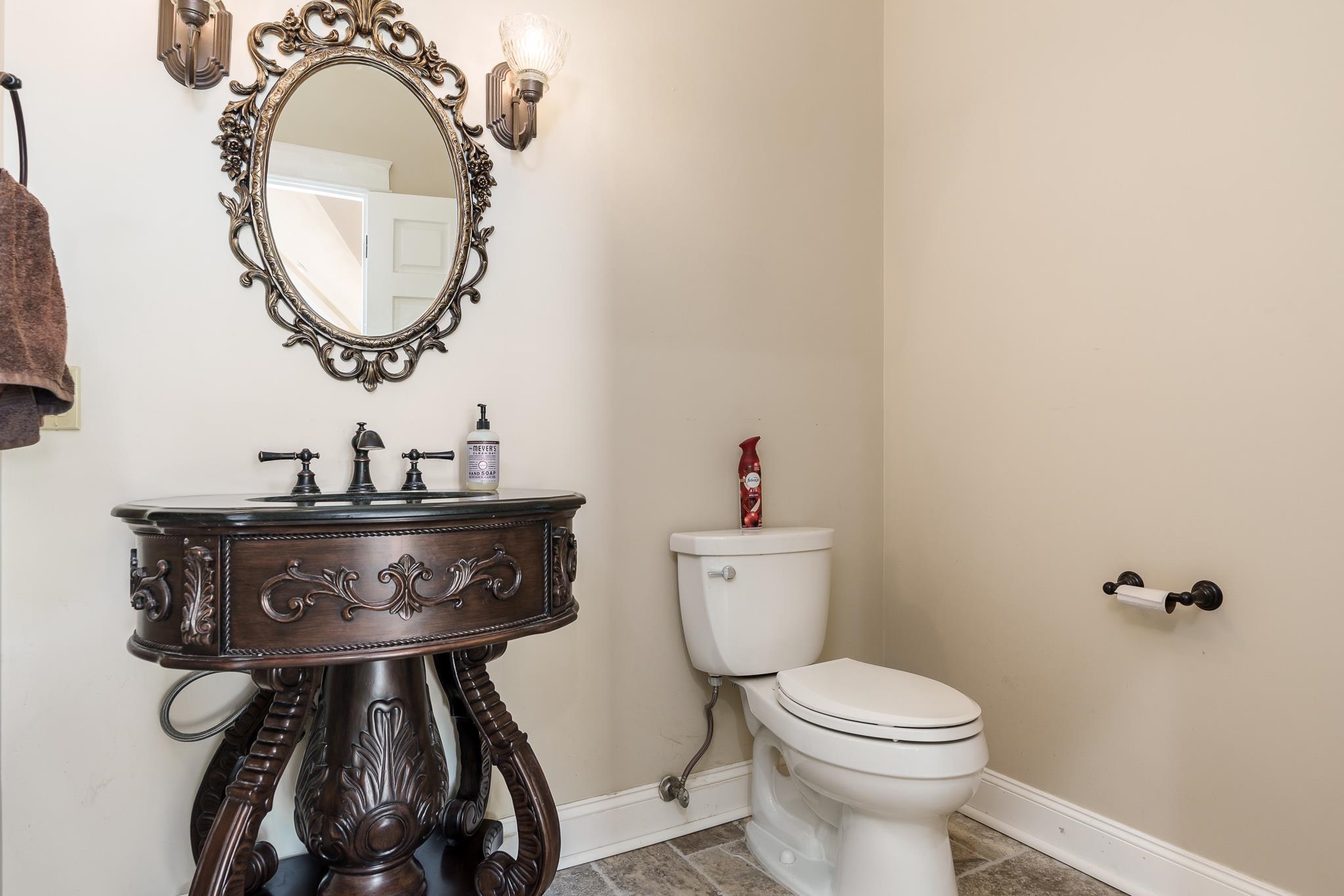 14949 Saunders Road Pecatonica, IL 61063 - Photo 16 of 88 a bathroom with a toilet a sink and a mirror