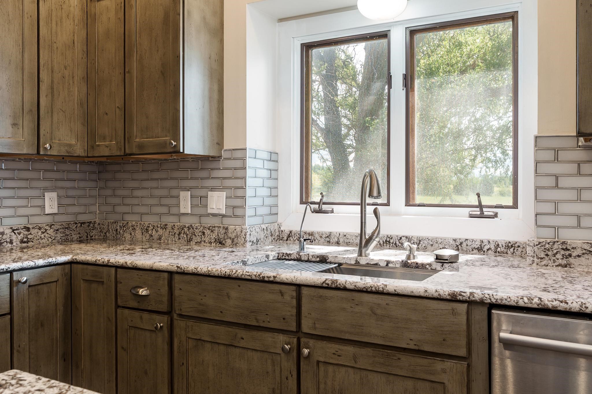 14949 Saunders Road Pecatonica, IL 61063 - Photo 25 of 88 a kitchen with granite countertop sink and window