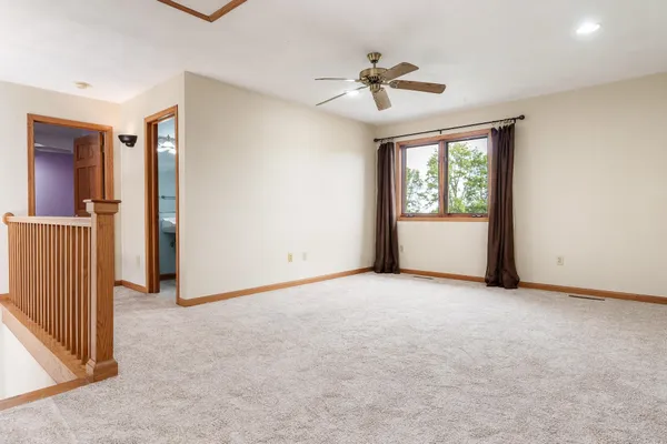 a view of an empty room with a ceiling fan