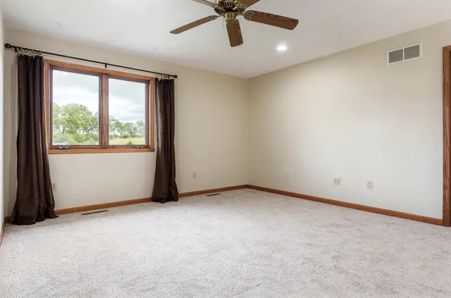 a view of a chair and table in the garden