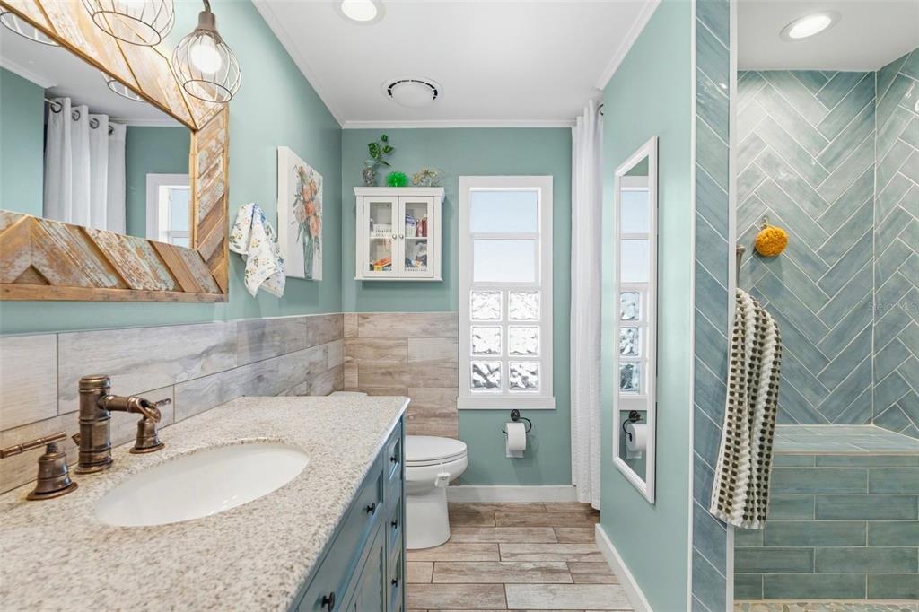 970 Jolanda Circle Venice, FL 34285 - Photo 15 of 34 a bathroom with a granite countertop sink a toilet a mirror and shower
