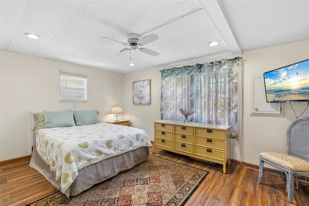 970 Jolanda Circle Venice, FL 34285 - Photo 17 of 34 a bedroom with a bed and a flat tv screen on dresser