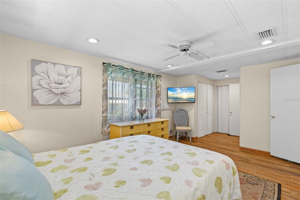 970 Jolanda Circle Venice, FL 34285 - Photo 18 of 34 a bedroom with a bed and dresser with wooden floor