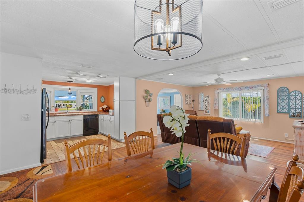 970 Jolanda Circle Venice, FL 34285 - Photo 7 of 34 a view of a dining room with furniture a chandelier and wooden floor